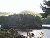 Glencorse Reservoir with Turnhouse Hill in blazing sun in the background