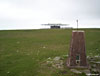 The trig point and Chimera Development Centre on the summit of Broad Law