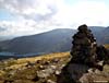 The cairn on North Gairy Top with Loch Dungeon and the Rhinns of Kells behind